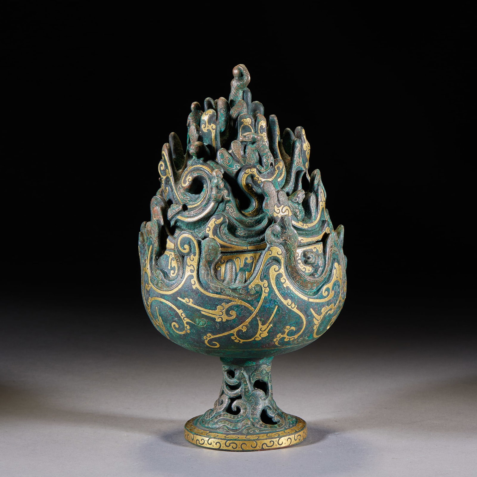 Boshan Hill Censer with Inlaid Gold, Mountains-and-Hundred-Beasts Design: Bronze-bodied, inlaid overall with gold. The cover is shaped as a layered Boshan hill; among the peaks are carved dragons, phoenixes, mythical beasts and figures in dense tiers. The belly is rounded a