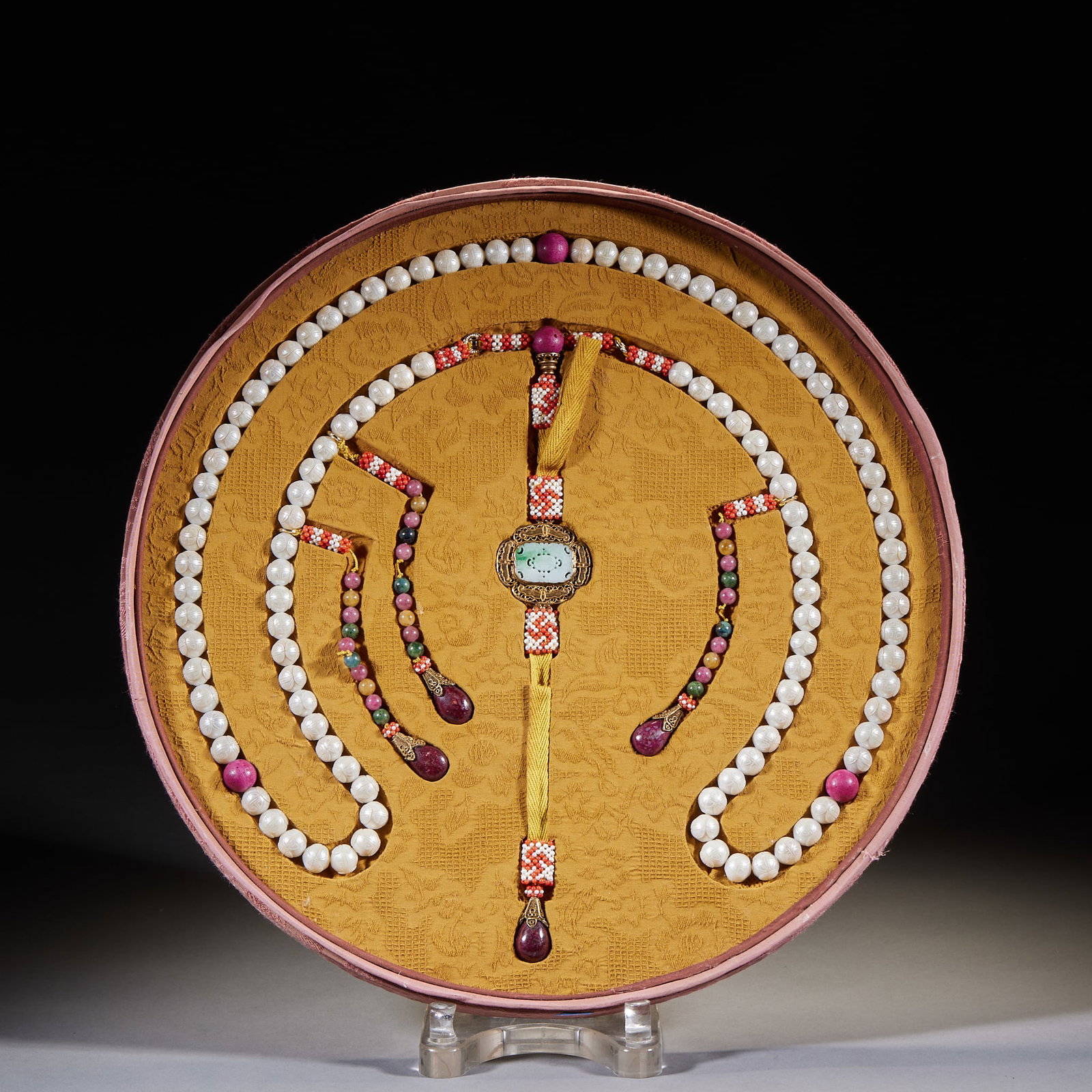Pearl Carved Fu-Shou Multi-Treasure Court Necklace: Kept in a round brocade box lined with yellow satin. The main beads are white pearls with purple-red spacer beads, accented with red-green gem ornaments, a jade back-cloud pendant and purple-red