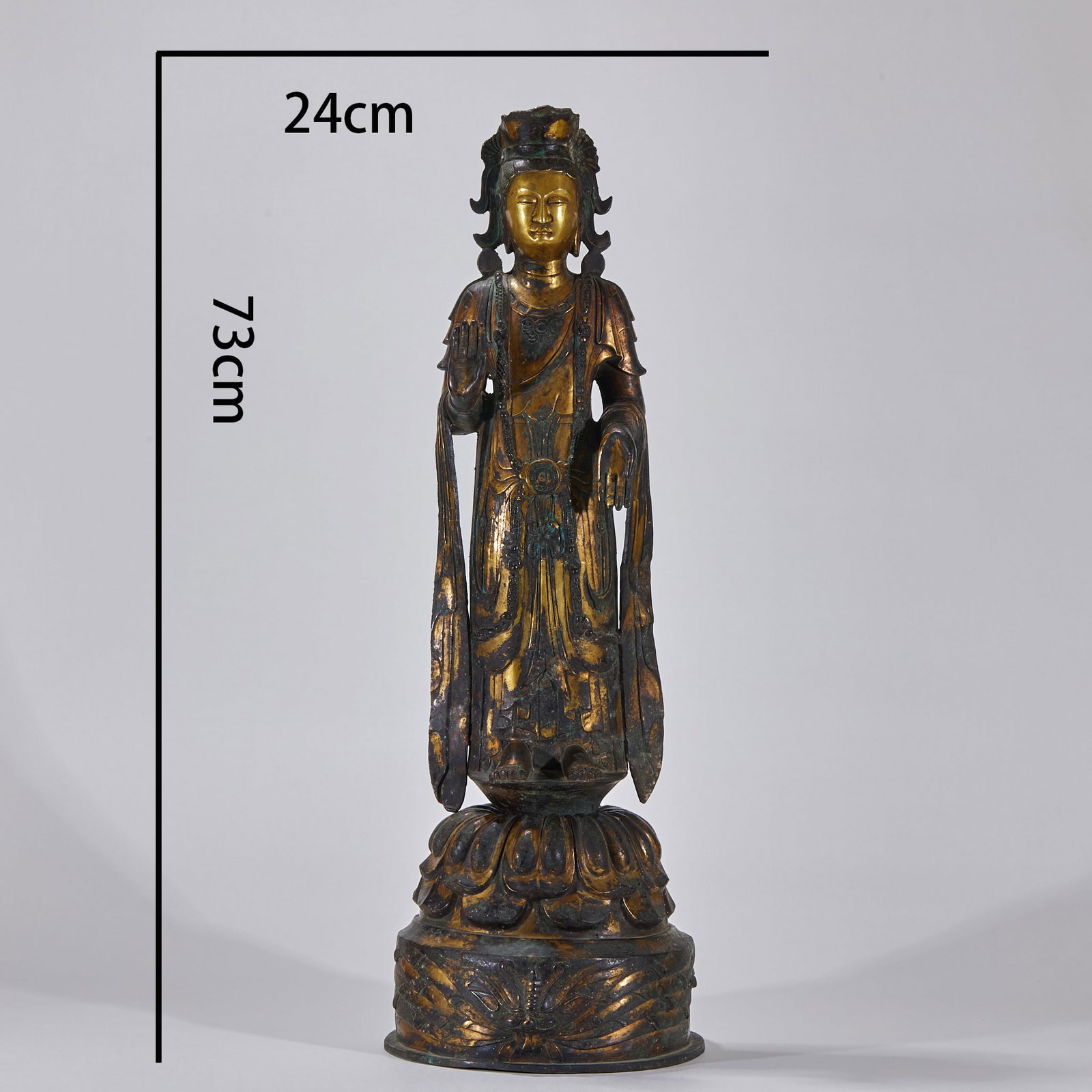 Gilt Copper Guanyin, Northern Wei: Total H 73 cm, W 24 cm; copper-bodied and gilded, with verdigris. The Guanyin stands on a double-lotus base, wearing a crown; the right hand makes the abhaya (fearless) mudra. The robes and jewelry
