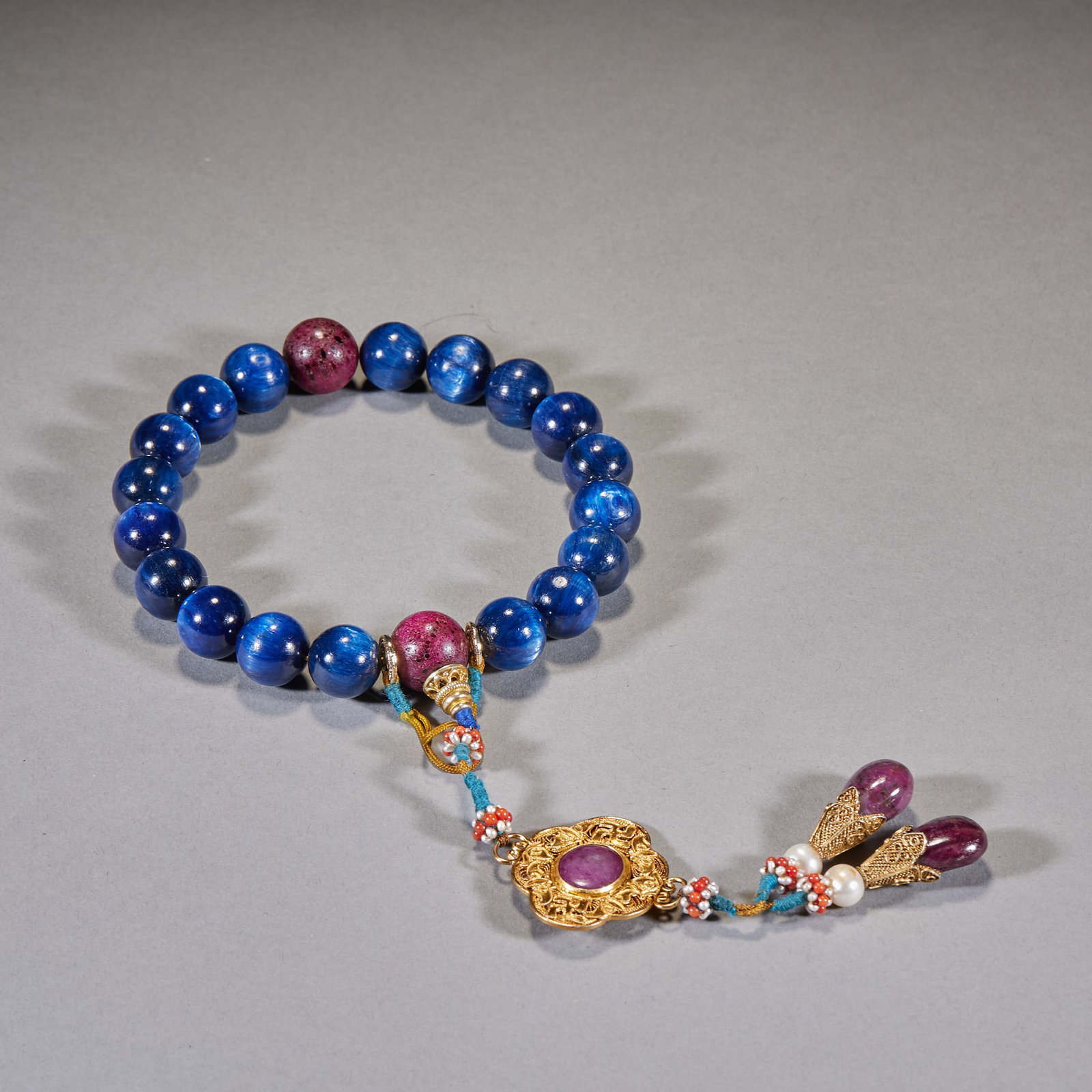 Gemstone Cat's-Eye Hand-Held Beads: The main beads are deep-blue lapis lazuli with purple-red spacers, a gilt floral back-cloud, and pendants of ruby and pearl. Single bead diameter 1.5 cm, 141 g.