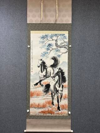 Xu Beihong Horse: Ink-and-colour hanging scroll of two horses galloping over a meadow with old pines and distant mountains behind; bold, dynamic brushwork in Xu Beihong's horse style, in original old mounting, with
