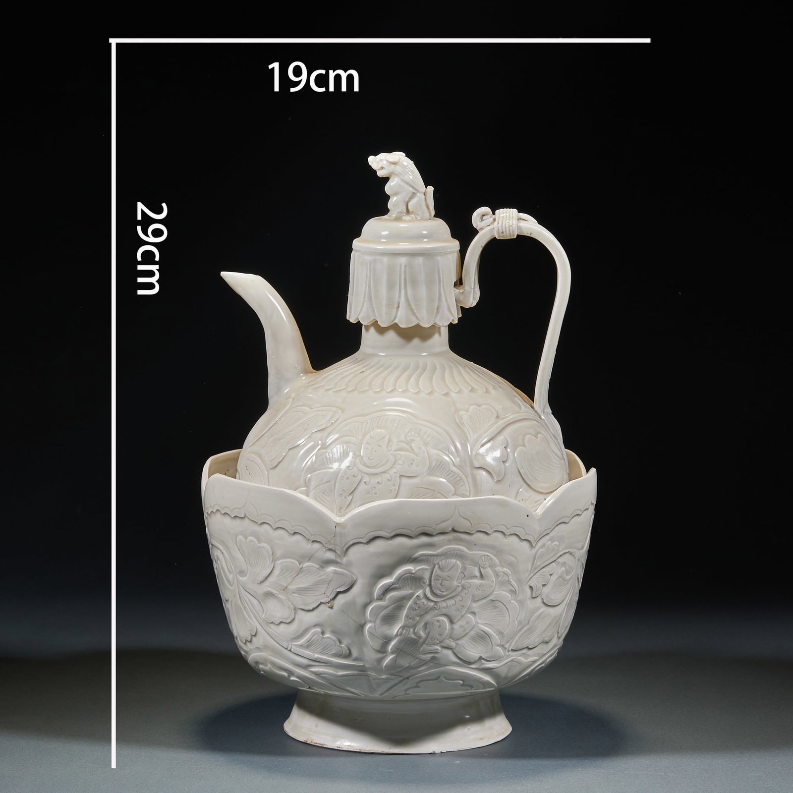 Ding Ware Wine-Warming Set: A set of two: an ewer and a lotus-petal warming bowl. The ewer lid has an auspicious-beast knop; the body is carved throughout with boys amid lotus ponds; a long spout and curved handle, the handle