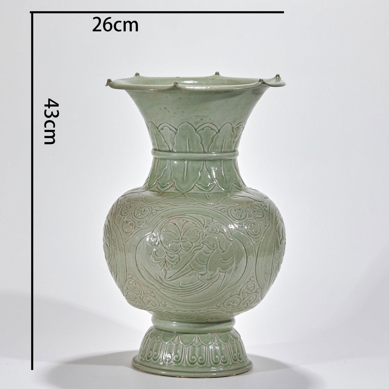 Yue Kiln Flower-and-Bird Vase with Panels: With flower-shaped mouth, long neck, rounded belly and high foot ring, glazed overall in celadon. The neck bears upturned-lotus band, the belly panels are carved with flower-and-bird scrolls, and the 