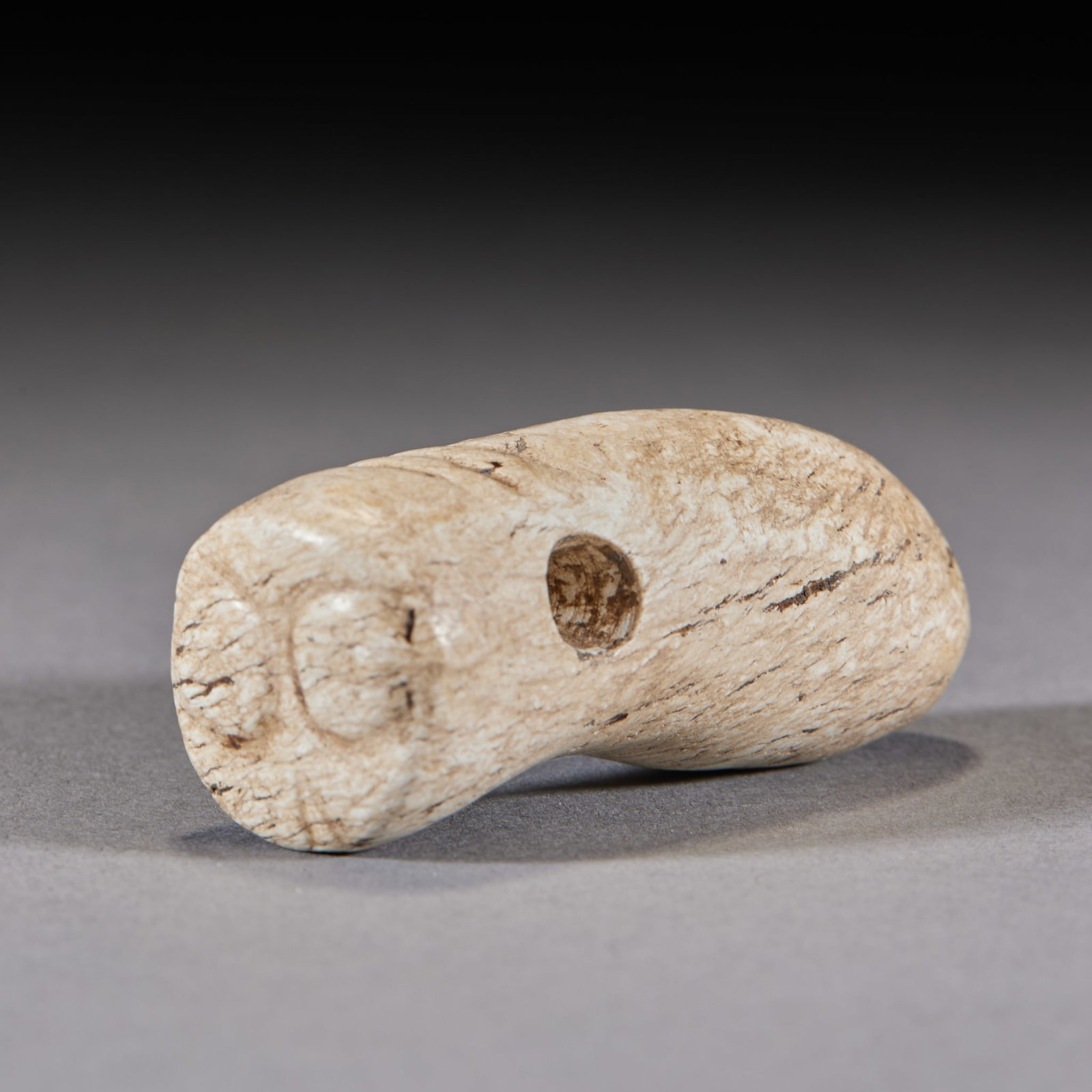 Hongshan Chicken-Bone-White Jade Cicada: A chicken-bone-white ancient jade in beast form with a perforation ?? a high-antiquity jade pendant. Whitened by long burial, worn by ancients as a hanging ornament. H 5.3 cm, L 2.1 cm, 40 g.