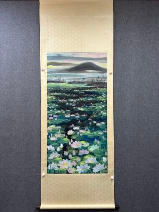 Lin Fengmian Lotus: Colour on paper, hanging scroll showing a large lotus pond full of blooms and leaves with a distant lake and hills ?? a modern ink-and-colour painting mounted in traditional scroll form for hanging.