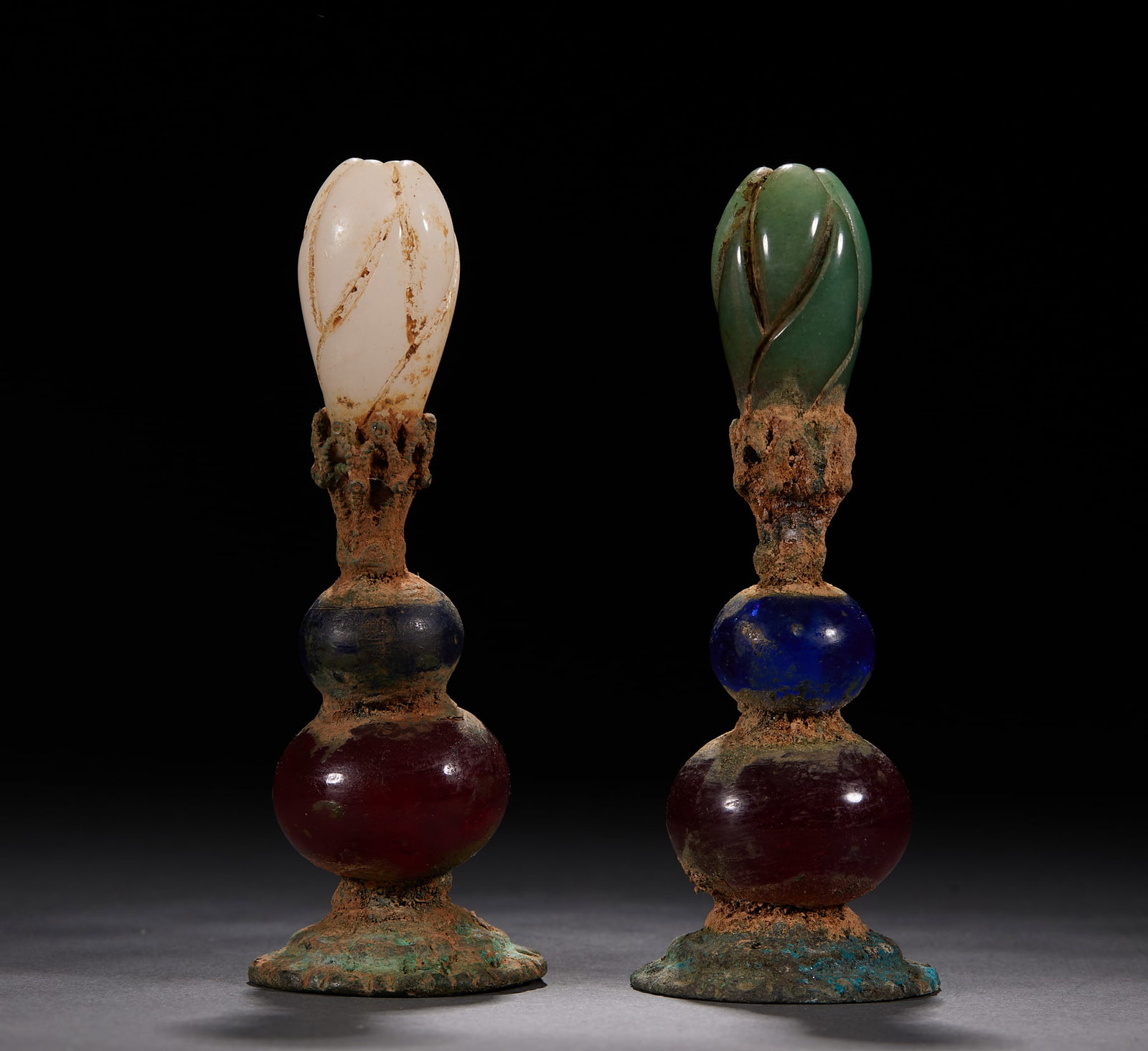 Glass Official's Hat-Finial: A Qing official's hat finial on a gilt-copper base layered with multi-coloured glass beads, topped with a white-and-green jade magnolia bud. Hat finials distinguished official rank in the Qing; a