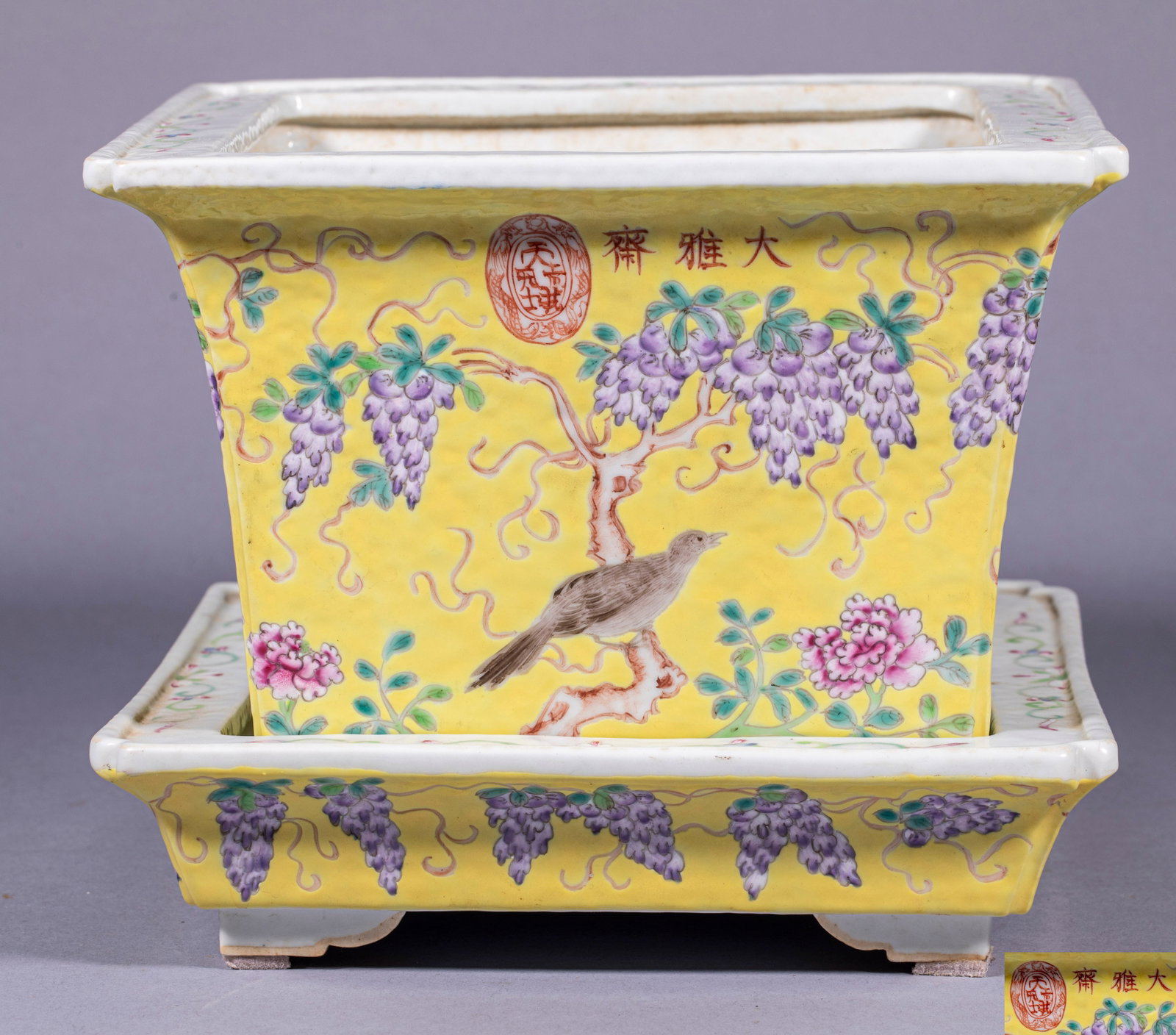 Dayazhai 'Many Sons Many Blessings' Flower-and-Bird Flower Pot with Saucer: Yellow-ground famille-rose, square with notched corners, with a matching coloured base. The walls are painted with wisteria, resting birds and peonies, and the red oval mark 'Dayazhai' and 'Tian Di