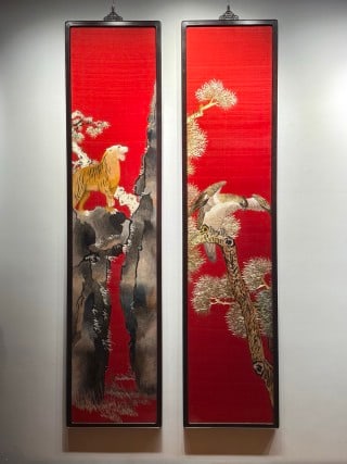 Late-Qing Hunan-Embroidery Pair of Panels 'Tiger Roaring in the Mountain' and 'Eagle Perched on an: A pair of vertical hanging panels on a bright-red ground. The left depicts a tiger on a rocky pine-clad slope, the right an eagle perched on an old pine, worked in kesi or embroidery with painted