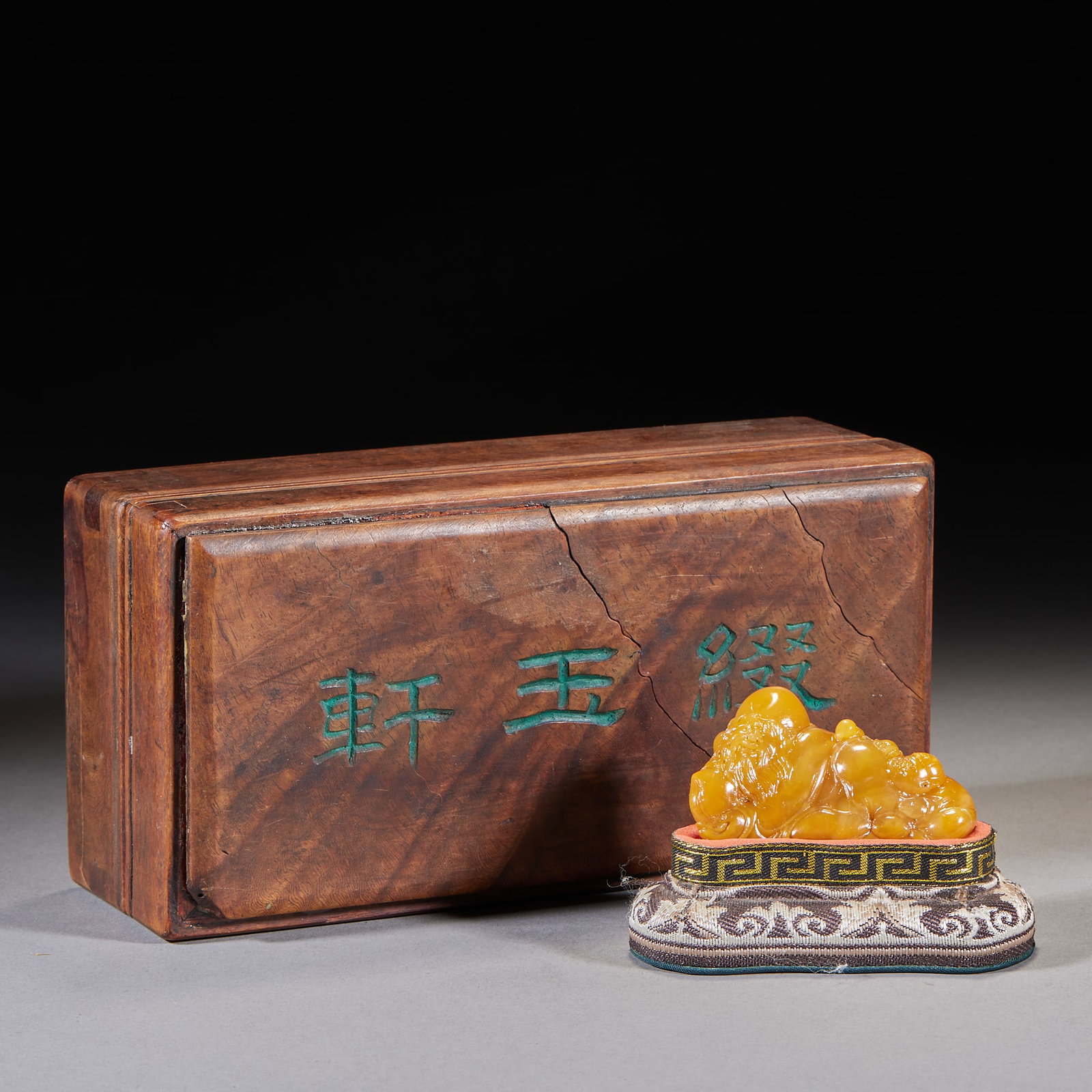 Zhuiyu Xuan Yu-Xuan Tianhuang Stone Reclining Maitreya Hand-Held: Tianhuang stone carving of an arhat, in an original old wood box carved with the characters 'Zhuiyu Xuan'. The tianhuang is warm, translucent, honey-yellow; the arhat is carved with a boy, expressions