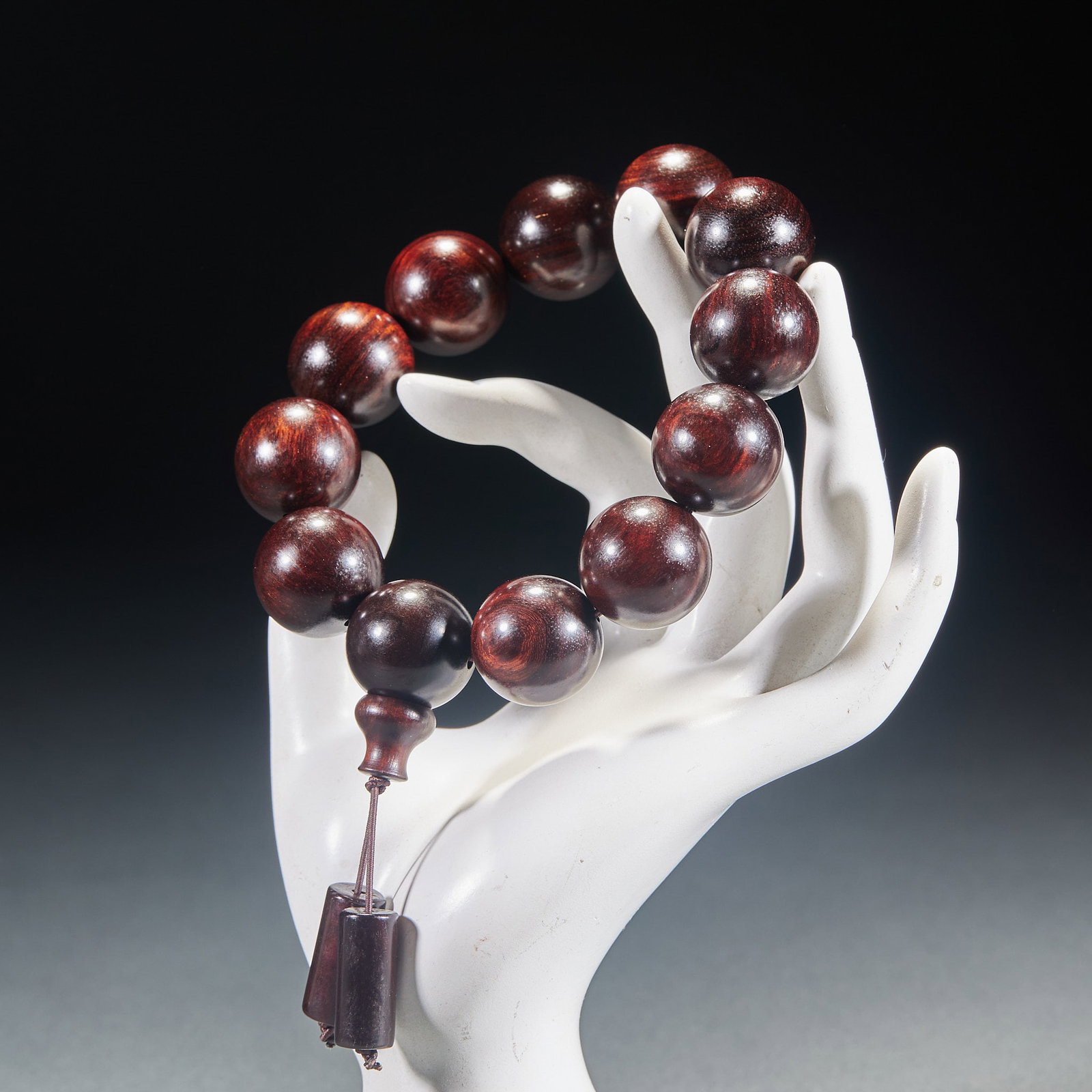 Zitan Twelve-Bead Bracelet: Of 'oil-huang' (oil-ripe) material, deep purple-red with clear grain and natural 'ghost-eye' markings, with matching buddha-head and pendant beads. Huanghuali is a precious hardwood long prized for
