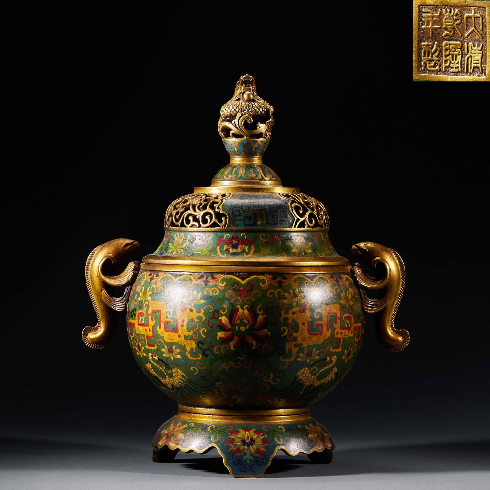 Cloisonn?? Flower-and-Beast-Ear Incense Burner with Dragon-Head Ears, Qianlong: A large covered incense burner topped with a coiled-dragon knop, the cover pierced for smoke, with fish-shaped gilt ears on both sides. The body is enamelled overall with scrolling lotus, kui-dragons 