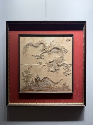 Republic Embroidery 'Gathering of Heroes in Wind and Cloud': A square shallow-relief panel: a grey dragon winds in high relief above a man looking up, beside trees and rocks; mounted with rosewood frame and red velvet lining. L 73 cm, W 69 cm.