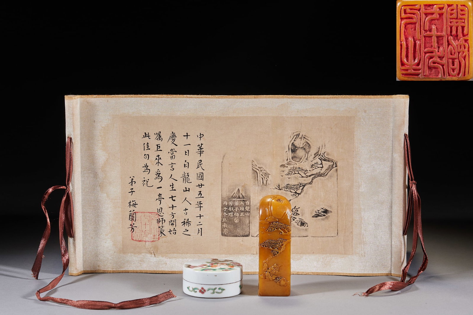 Tianhuang Seal with Julai Seal-Carving, Presented by Mei Lanfang to Bai Longshanren: A rectangular tianhuang seal with a thin-style carving of a landscape-figure scene under pines on the side, supplied with a famille-rose floral seal-paste box and a mounted rubbing with Mei Lanfang's 
