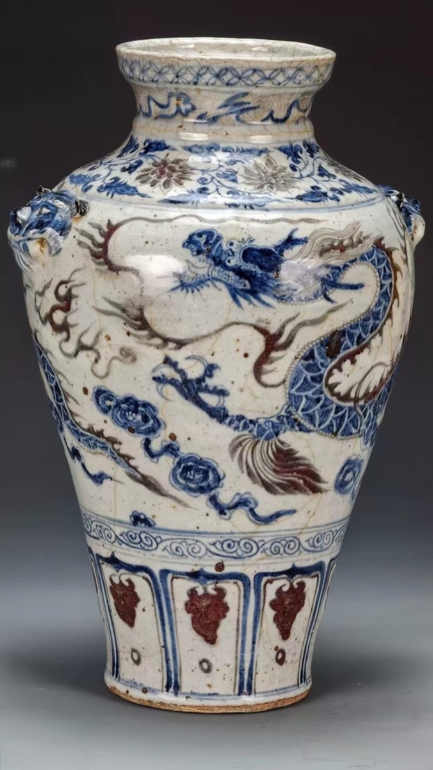 Copper-Red Cloud-Dragon Dish-Mouth Display Vase: Dish mouth, short neck, beast-head ears on both sides. The crazed-glaze body is painted with underglaze-blue cloud-dragons accented with copper-red flames; the neck and shoulder bear scrolling floral 