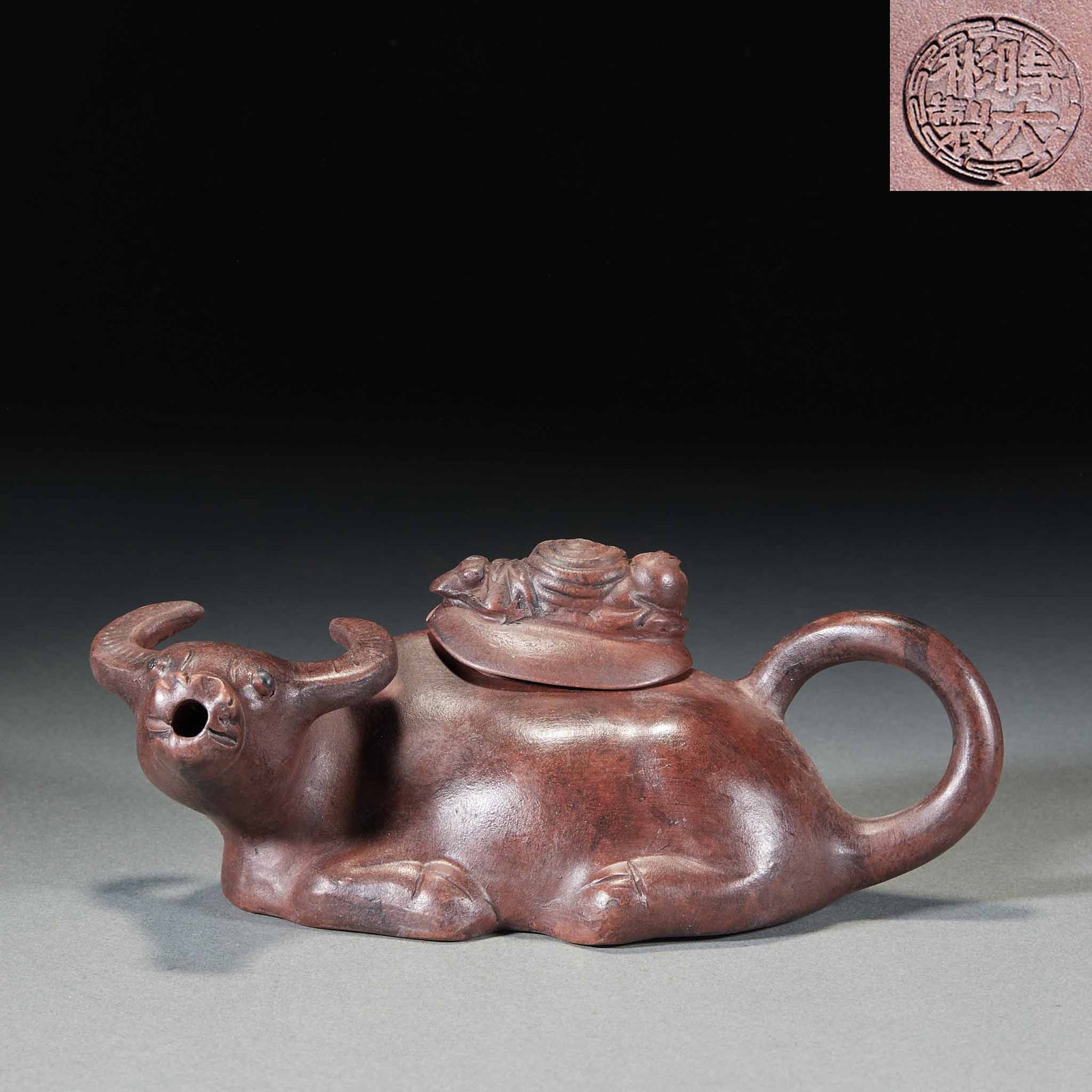 Shi Dabin-Marked 'Ni Qi Chong Tian' (Bull-Spirited) Zisha Teapot: A zisha bogus-object flower vessel with a seal mark at the base. The whole teapot is modelled as a reclining bull, the bull's head as spout and the curled tail as handle; the lid has a cowherd boy