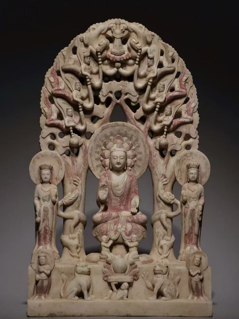 White-Marble Sakyamuni Preaching: A white-marble triad of one Buddha and two bodhisattvas retaining traces of old colour. The principal Buddha sits in lotus position flanked by Guanyin and Mahasthamaprapta. A huge openwork tree-form