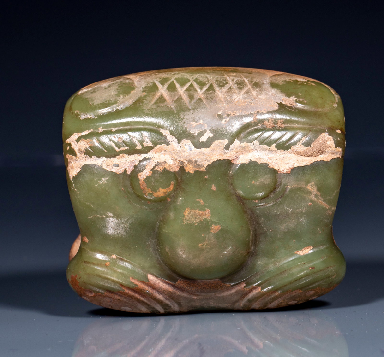 Carved-Tiger Jade Cong: A jade cong of inner-round-outer-square columnar form, regular in shape. One face is carved in relief with a tiger, body coiled, head raised and mouth open, lines vigorous and formidable. The jade is