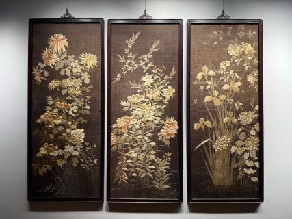 Late-Qing Republic Embroidery 'Flowers Blooming with Wealth' Set: Three framed rosewood embroidery hanging panels as a set, on dark grounds worked with gilt thread and colour: chrysanthemum, orchid and peony, the four-season flowers respectively. The stitches are