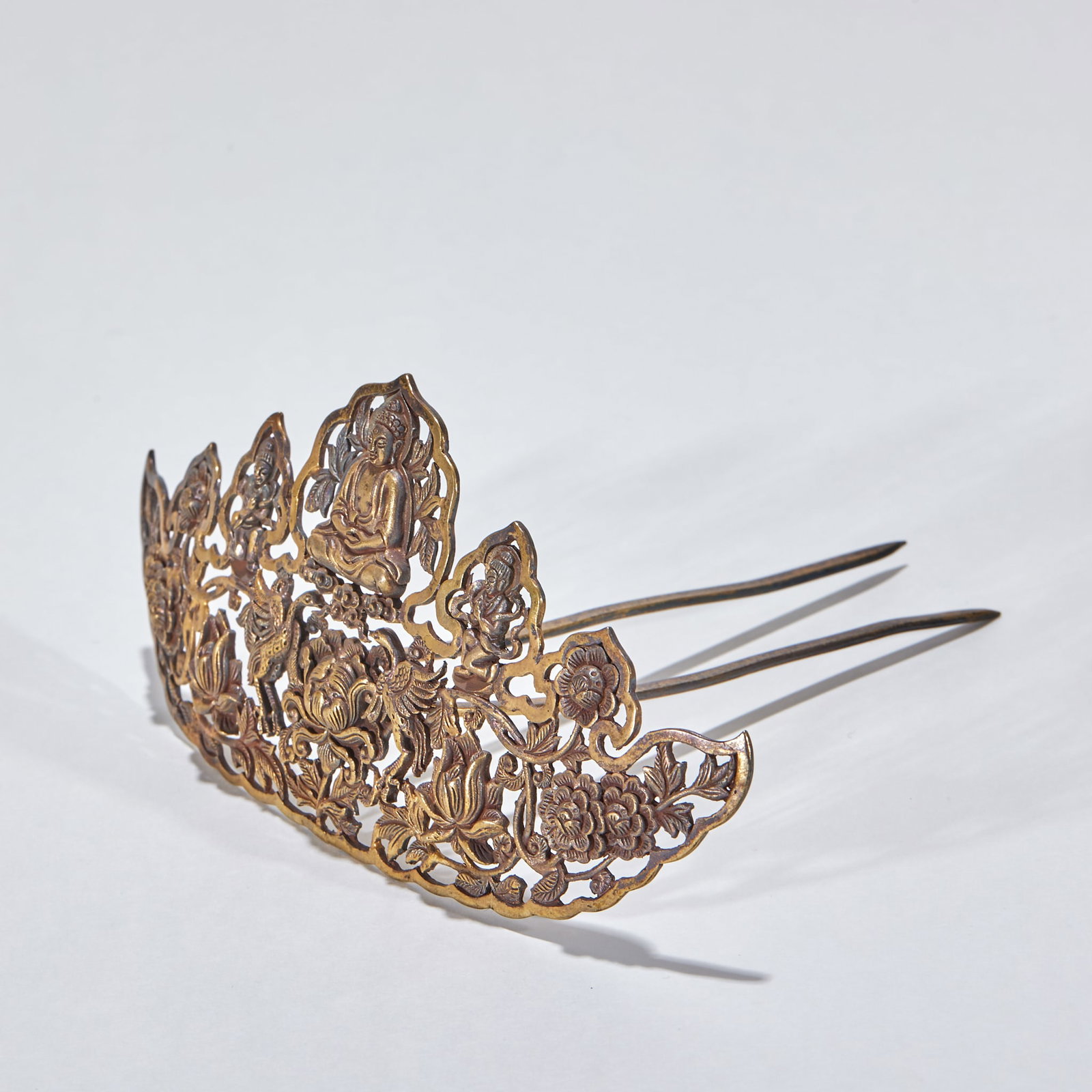 Gilt Silver Hair Ornament: A gilt-copper coronet made by openwork, layered with seated Buddhas, auspicious beasts, lotus and peonies, with two long hairpin prongs, elaborately worked ?? an ancient noble's headdress. L 14.5 cm,