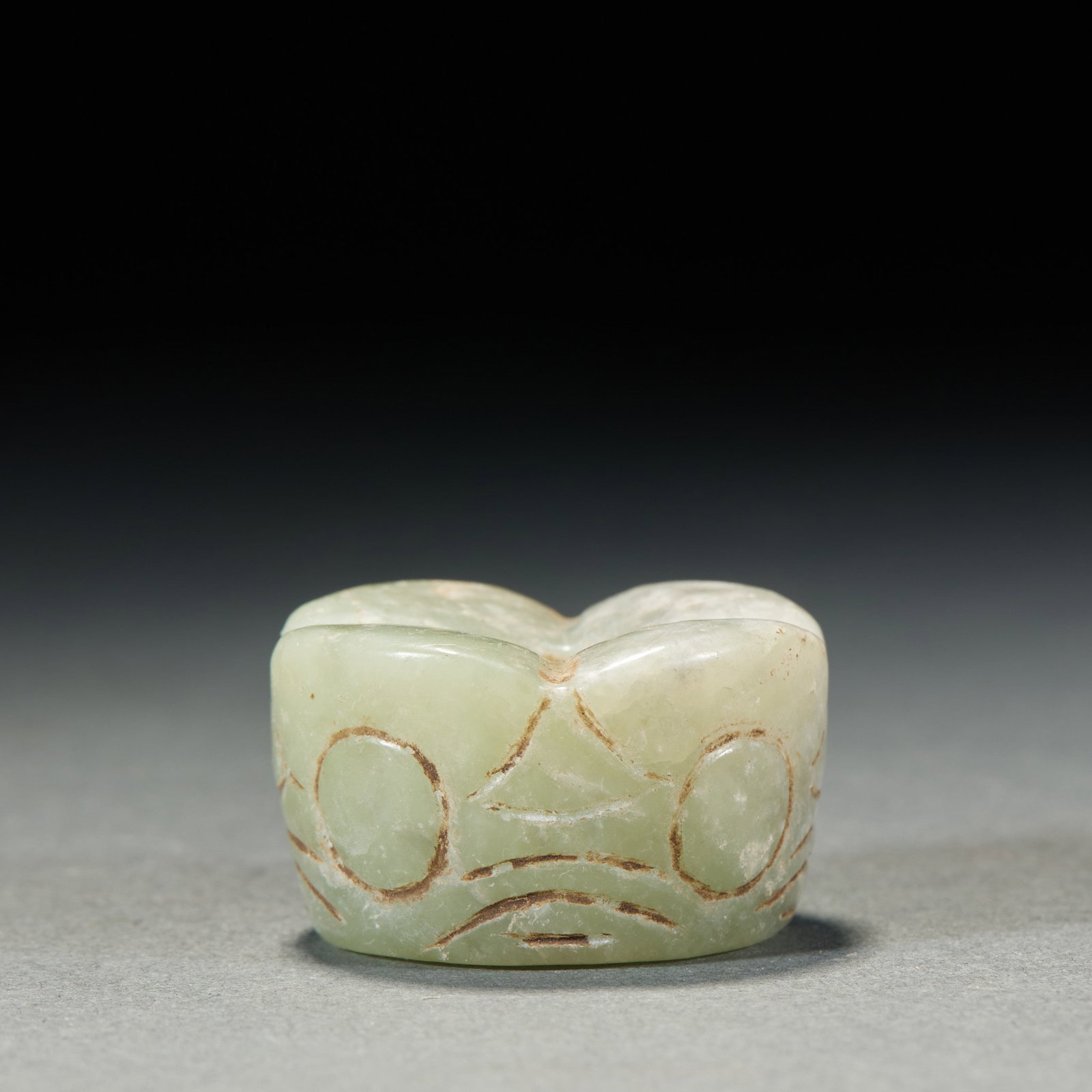 Deity-Mask Jade Cong-Form Object: A short greenish-white jade cylinder lightly incised with a beast-mask pattern in simple, plain lines; the jade is warm with natural ancient calcification, usable as a stringing component ?? a small