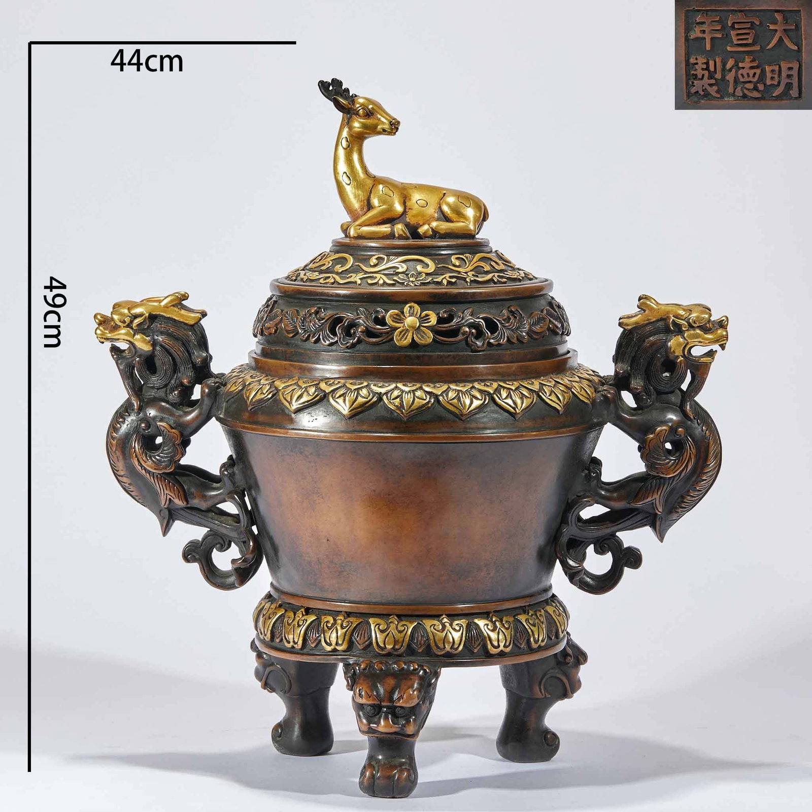 Xuande-Marked Gilt Copper Deer-Top Incense Burner: Copper-bodied, partially gilded, of large scale, H 49 cm. The cover bears a reclining-deer knop, two large dragon ears at the sides, three beast feet; the rim and base bear gilded lotus-petal