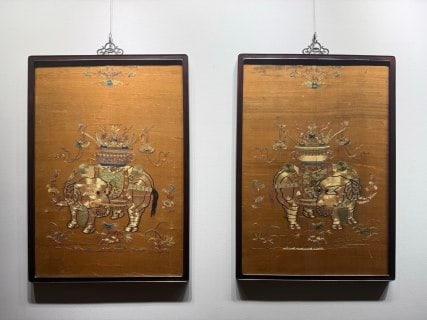 Mid-Qing Court Couched-Gold 'Peace with the Elephant' Pair: A pair of rosewood-framed embroidery hanging panels on yellow satin worked in couched-gold. The subject is an elephant carrying a precious vase, symbolising 'peace with the elephant', surrounded by