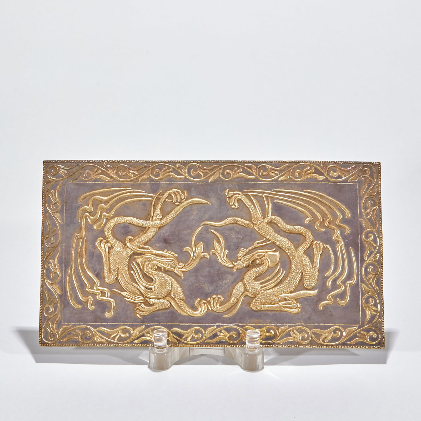 Gilt Silver Engraved Twin-Dragon Panel: A gilt-silver panel on a silver ground with partial gilding. The face is engraved with twin dragons threading through clouds to play with a pearl, scales distinct, lines fluid and powerful, the