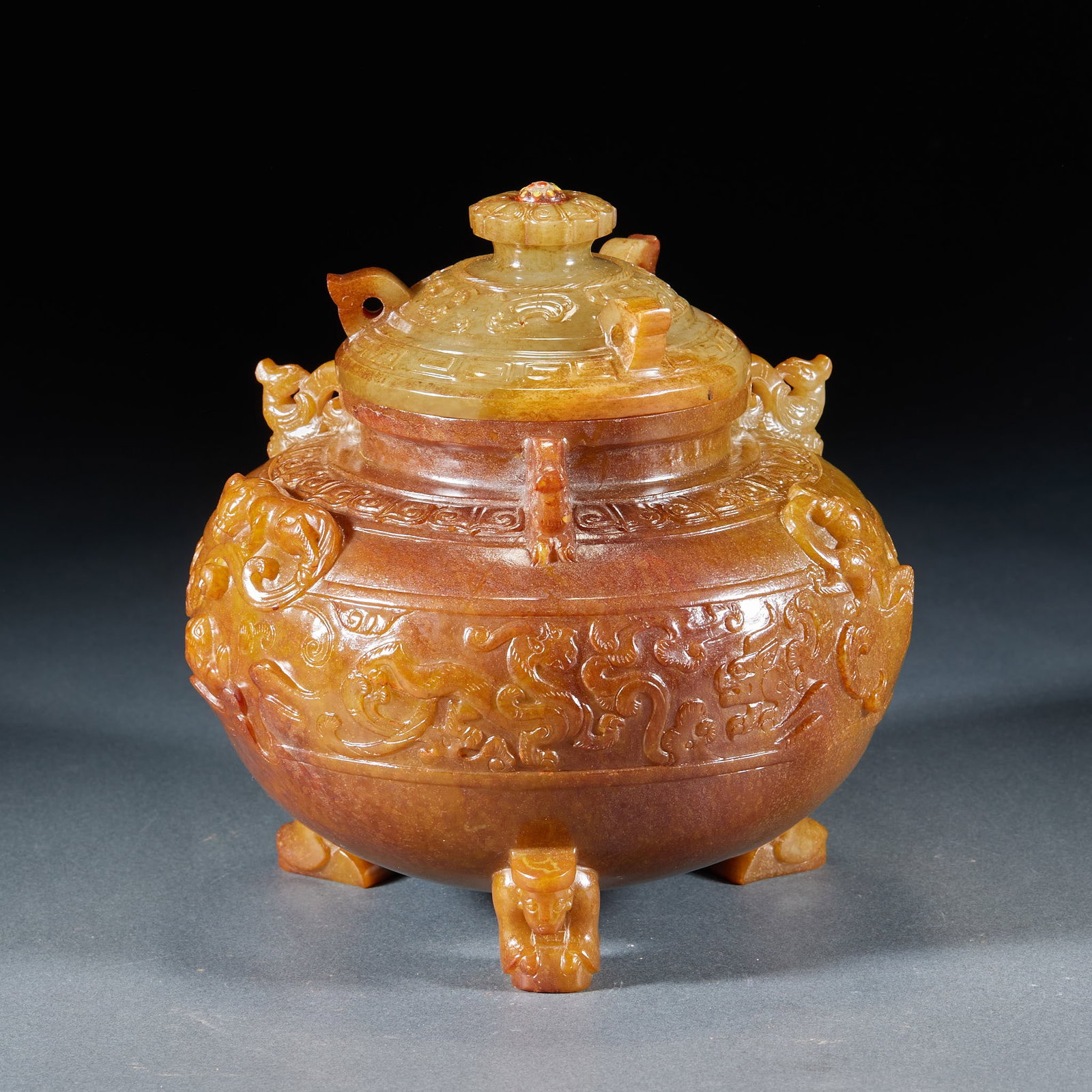 Pre-Ming Three-Footed Jade Covered Censer: A jade covered censer, round with three feet and a cover. The body is plain or banded, the jade warm and the form dignified. Three feet were the common form of pre-Ming jade censers; used for burning 