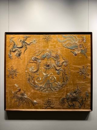 Qing Embroidery of Auspicious Beasts: A Qing embroidery with auspicious beasts ?? qilin and pixiu ?? fierce in pose. Fine, varied stitches and rich colour, set with clouds and rocks; symbolising good omen ?? a fine Qing embroidery. L 102