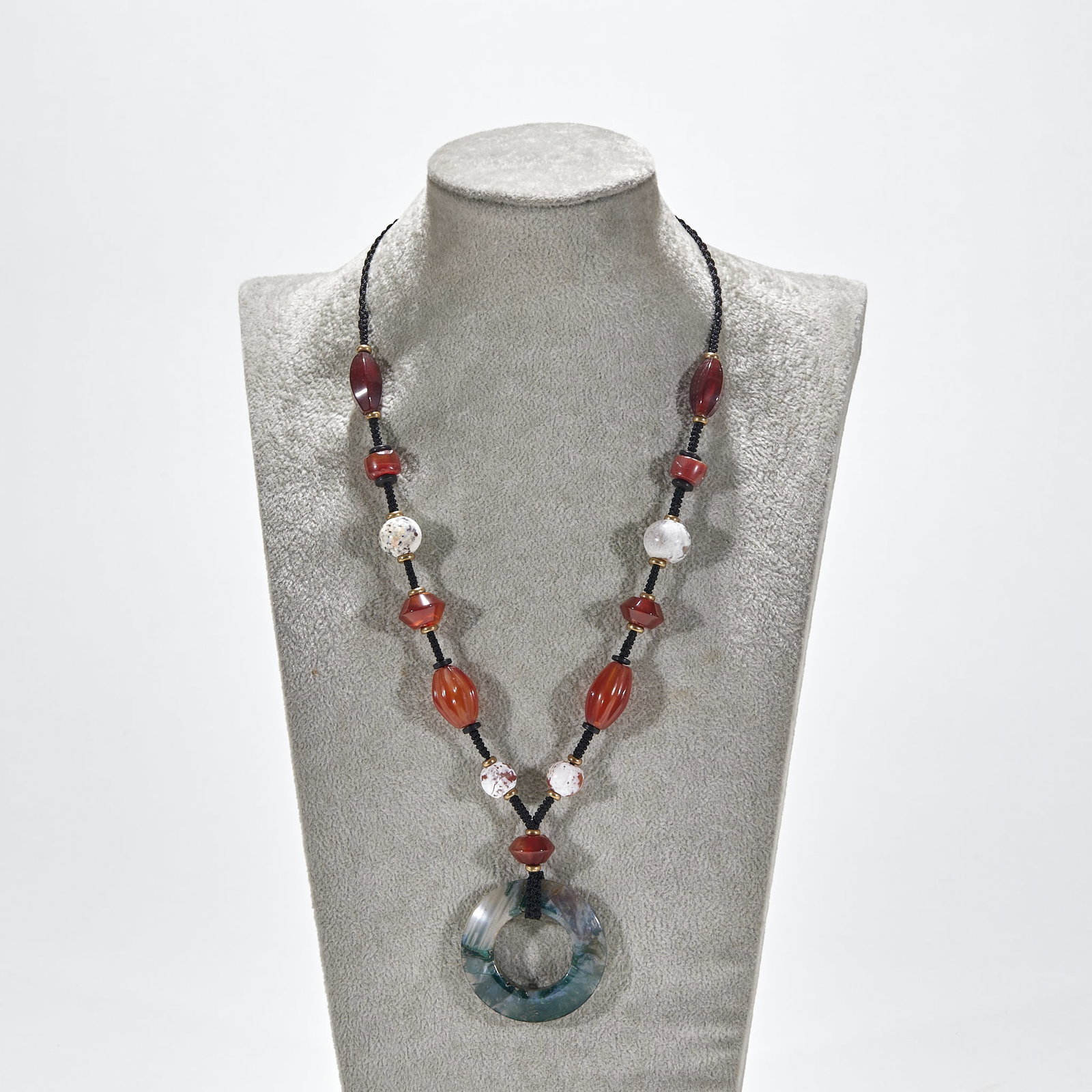 Agate Ring Pendant with Beads: An agate ring as the principal, strung with agate and crystal beads to form a pendant. The agate has magnificent grain and warm colour ?? worn at the neck, archaic and elegant. Ring diameter 4.5 cm.