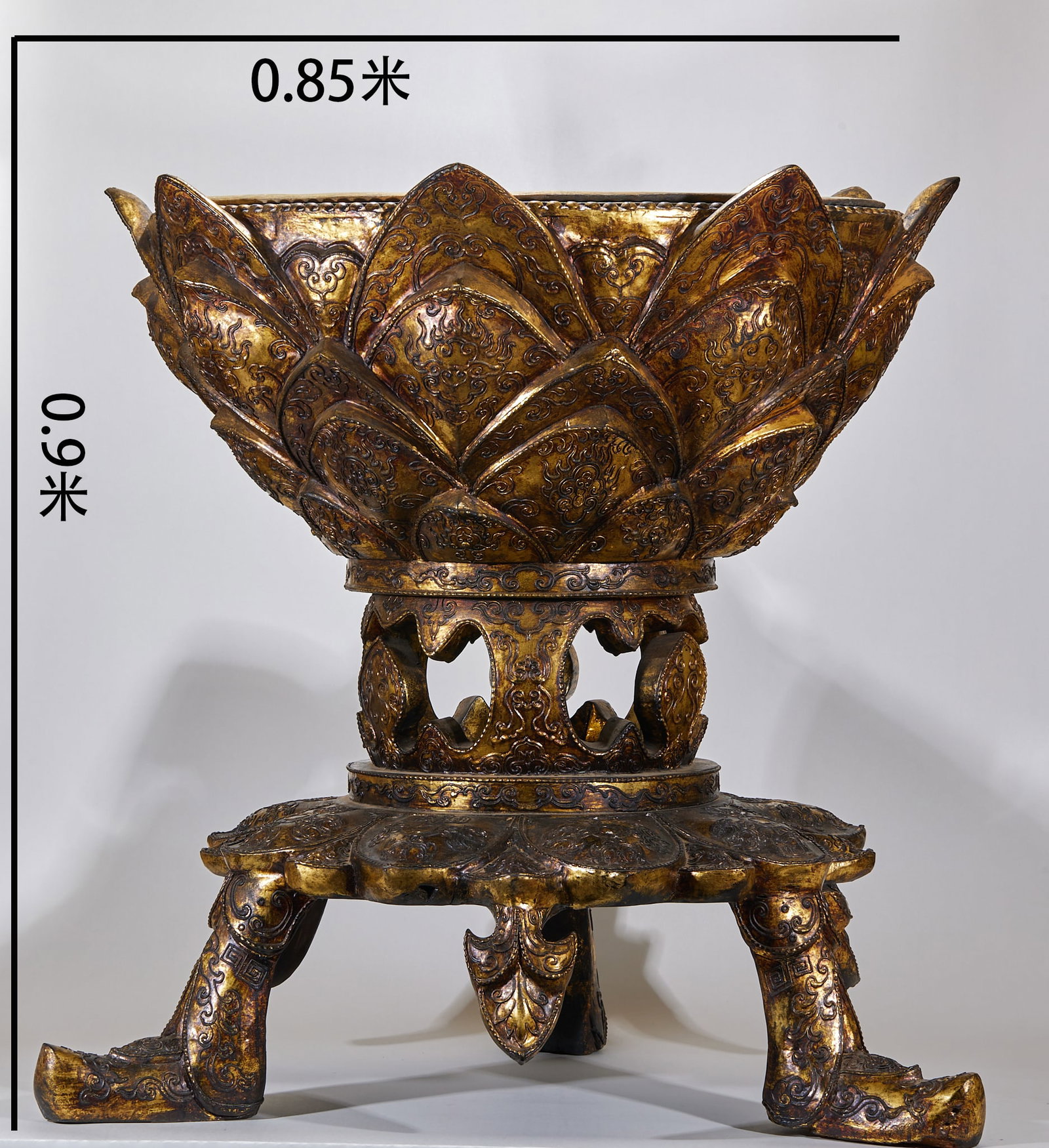 Gold-Foil Lotus Seat with Gilt Copper Basin: A wood-bodied gold-foil lotus seat with a lotus-shaped face, gold-foil decoration of warm gold, carrying a gilt-copper basin. An offering or display vessel before the Buddha, resplendent. H 90 cm, L