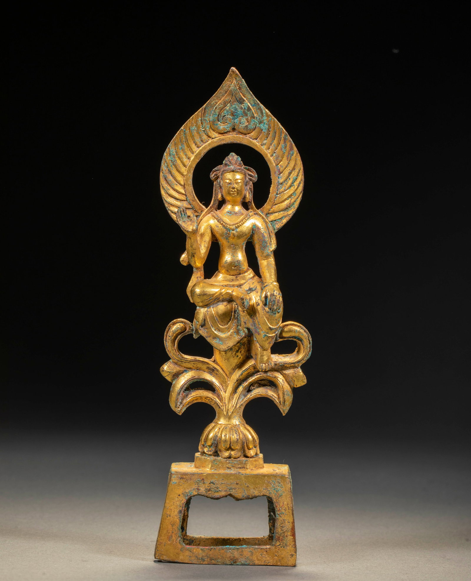 Pre-Ming Gilded Seated Buddha: A gilded seated Buddha in lotus position on a lotus throne, making the dhyana or teaching mudra, solemn face, eyes half closed. Gilded throughout with parts of the gilt well preserved ?? a pre-Ming