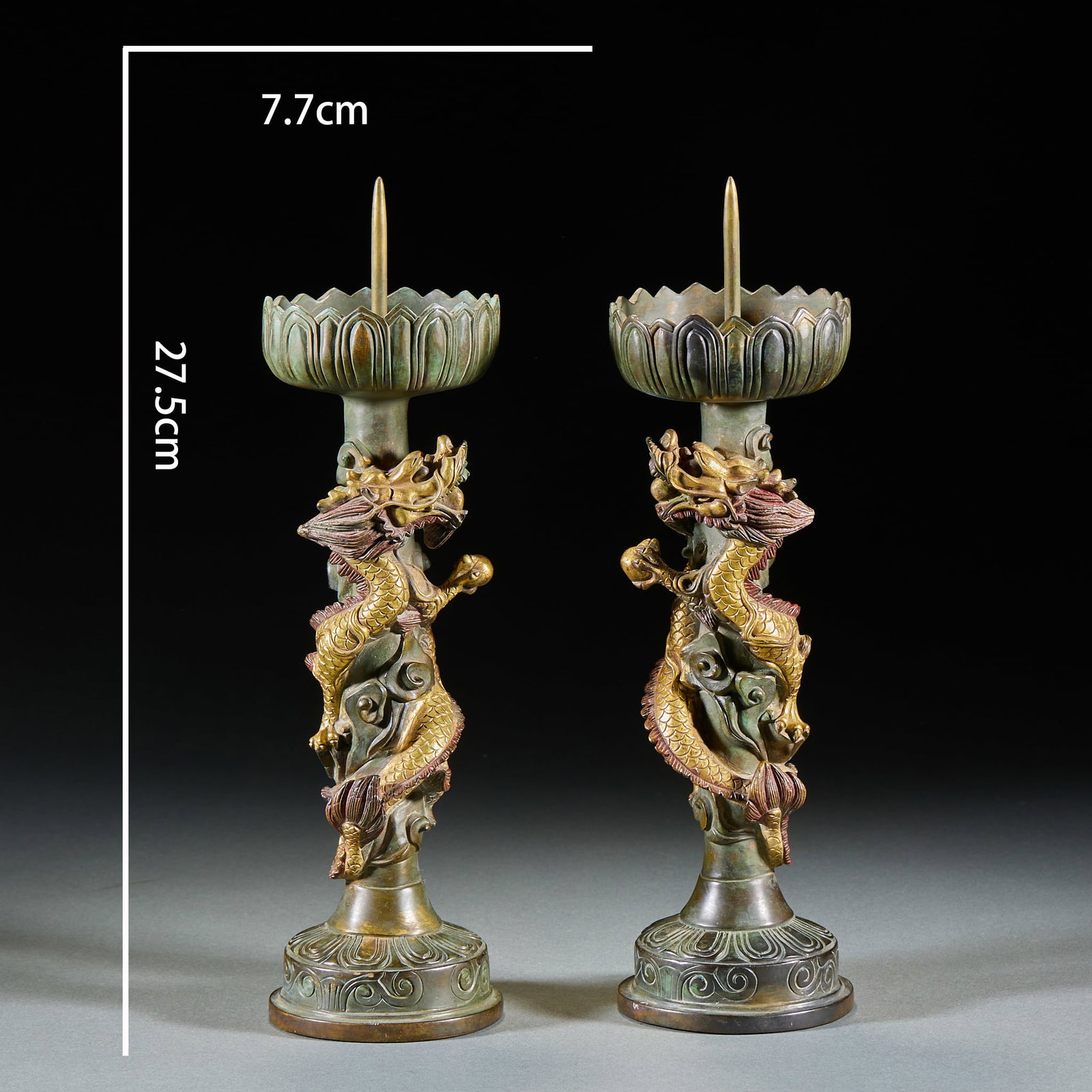 Pair of Partially Gilt Copper Dragon-Chasing-Pearl Lampstands: A pair of partially gilt copper lampstands decorated with dragons chasing a pearl, bodies coiling and holding the pearl, partly gilded, gold and copper interchanging. The pans hold lamps over bases,