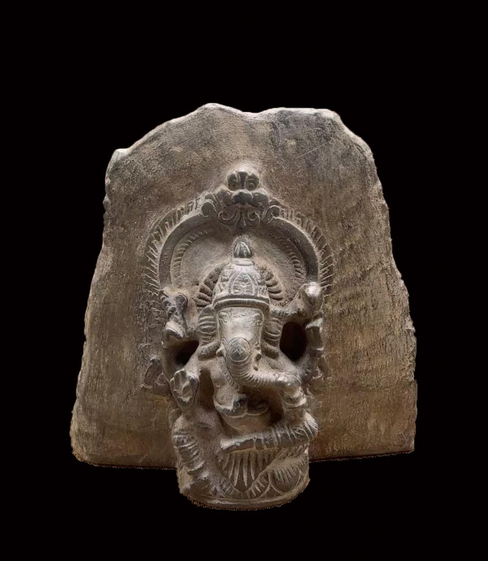 Stone Gandhara Elephant-Face Buddha: A Gandhara-style carved stone elephant-face Buddha, grey stone; the head or body bears Gandhara traits ?? snail-shell hair, deep eyes and high nose, solemn. The cutting is simple ?? an early image