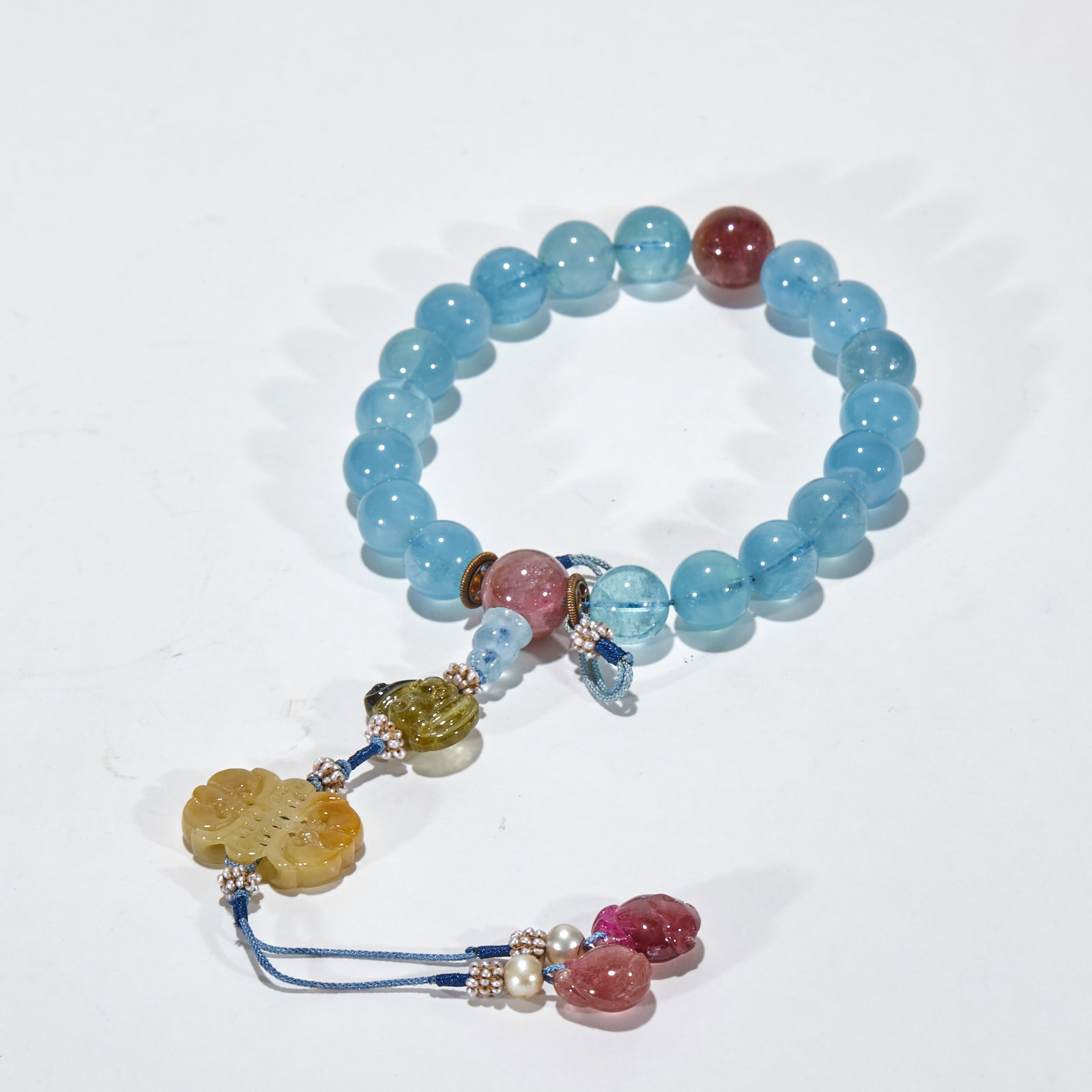 Aquamarine Hand-Held Beads: Aquamarine hand-held beads: clear pale-blue stones with buddha-head and pendant. For wearing or reciting, pure and bright, symbolising peace. Single bead diameter 1.3 cm, 84 g.