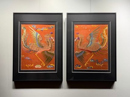 Pair of Qing Suzhou-Embroidery 'Phoenix Holding a Scroll': A pair of Qing Suzhou-embroidery phoenixes holding a scroll, wings spread, the phoenix holding a scroll in its mouth, symbolising good omen and literary fortune. Fine Suzhou stitches and muted colour,