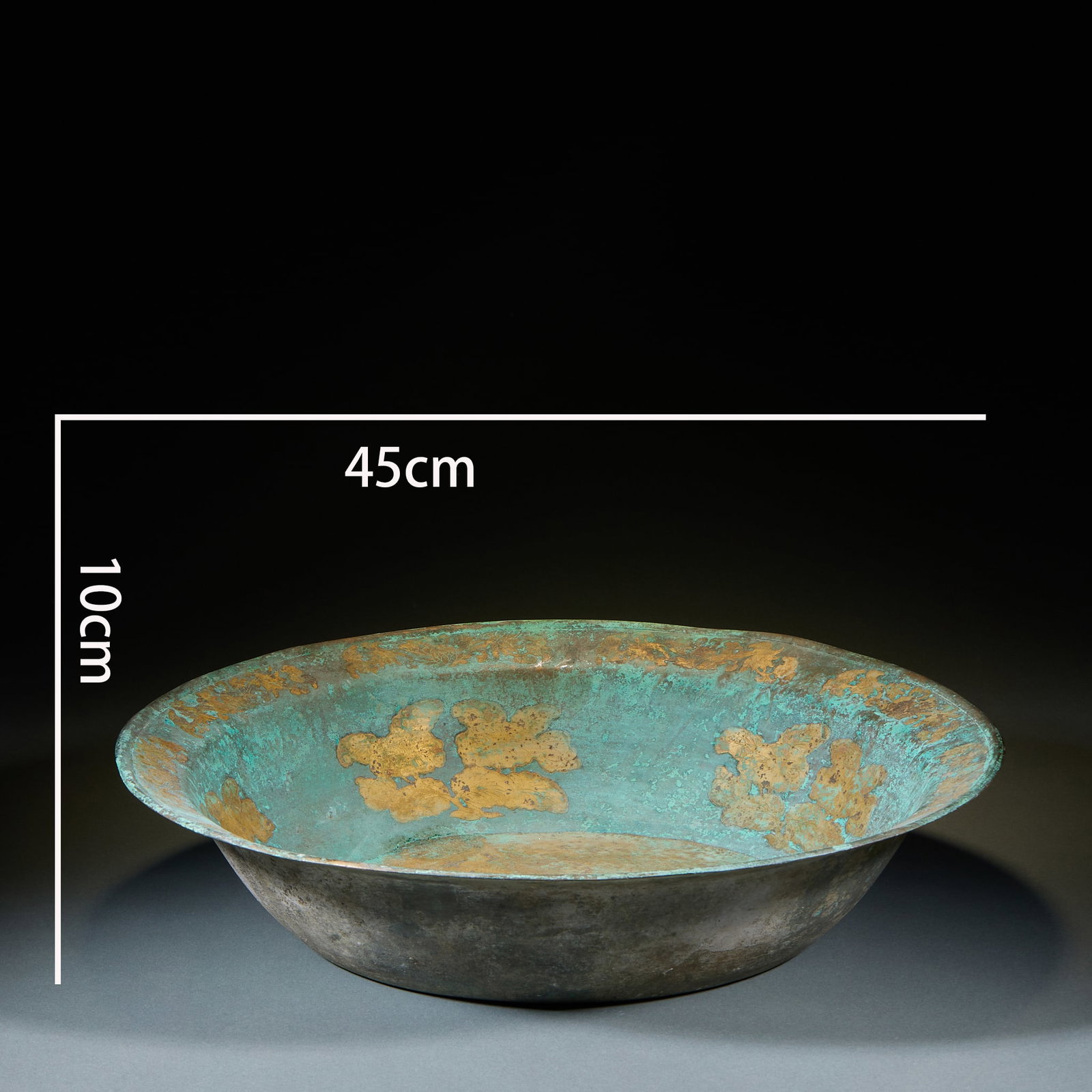 Gilt Copper Basin: A round gilt-copper basin with outward-folded rim, regular form. The gilding is bright and mirror-like ?? a court or noble's vessel, both practical and display. H 10 cm, Diameter 45 cm.