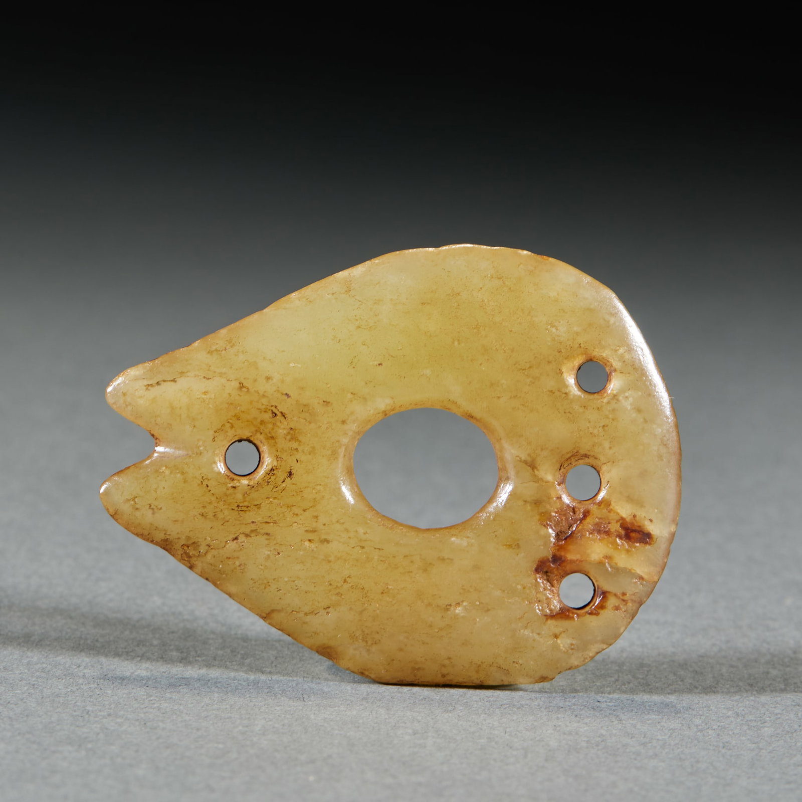 Hongshan Lingbi Pendant: A Hongshan-style lingbi pendant of stone or jade, simple in form, warm material, possibly calcified. A Hongshan-culture-style pendant, archaic and mysterious. L 5.3 cm, W 4.1 cm.