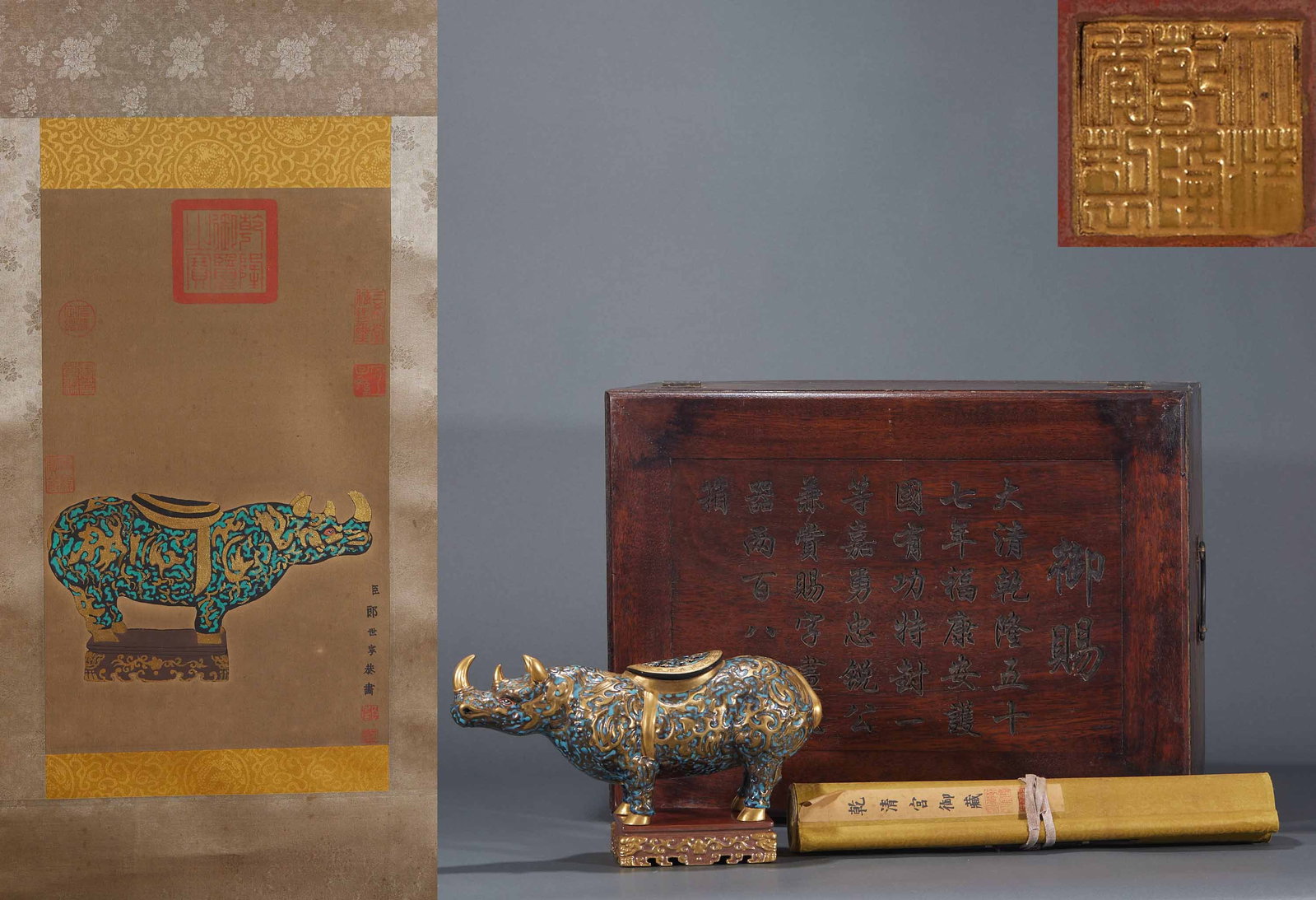 Qing Cloisonne Rhinoceros Ornament: A Qing cloisonne porcelain rhinoceros, powerful in build and brilliant in colour. A display piece symbolising good omen, finely made. H 15 cm, L 27 cm, W 9 cm; silk painting L 41 cm, W 24.5 cm.