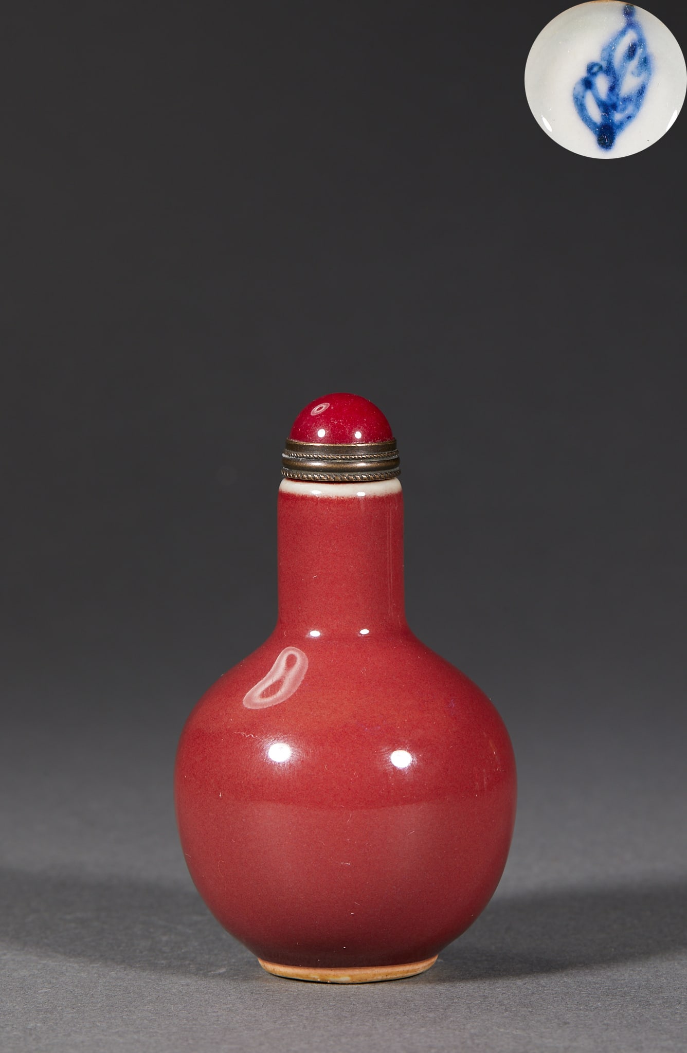 Qing Carmine-Red 'Leaf' Mark Snuff Bottle: A Qing carmine-red snuff bottle, the glaze a delicate red, possibly with a 'leaf' mark. Small with a stopper ?? a celebrated Qing snuff bottle. H 7.8 cm, Diameter 4.6 cm, 53 g.