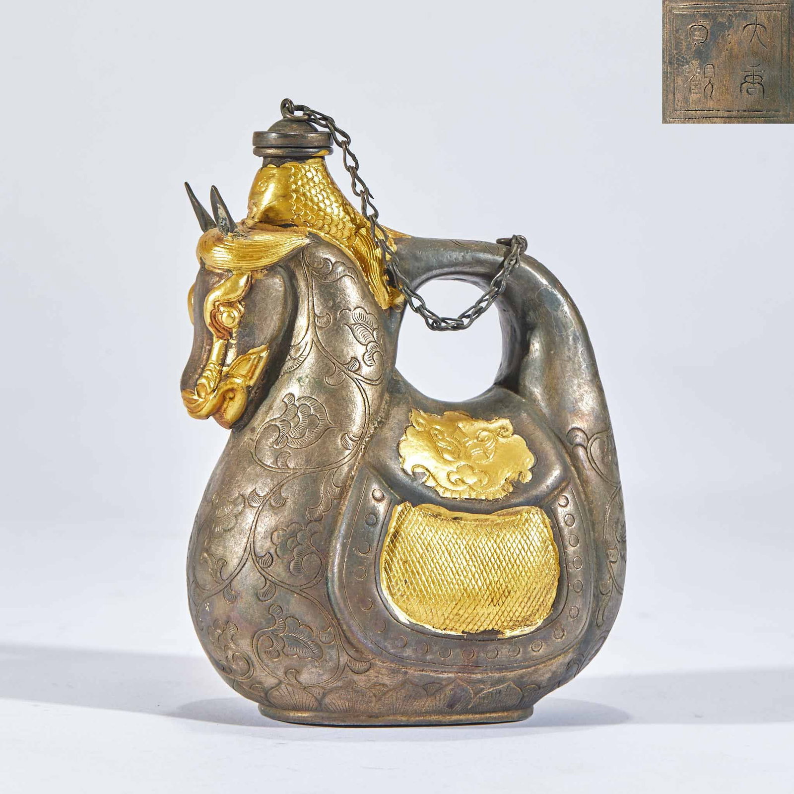 Partially Gilt Copper Horse-Head Ewer, 'Zhenguan' of the Great Tang: A partially gilt copper ewer whose spout is a horse head, the body partly gilded, the base inscribed 'Zhenguan of the Great Tang'. Unusual form with gold and copper alternating ?? a Tang-style copper