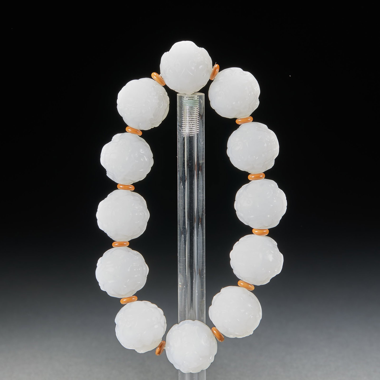 Hetian Jade Pixiu Bracelet: A bracelet strung of jade pixiu beads, varied in form, symbolising attracting wealth and fortune. The jade is warm and finely carved ?? worn on the wrist. Single bead diameter 1.9 cm, 110 g.