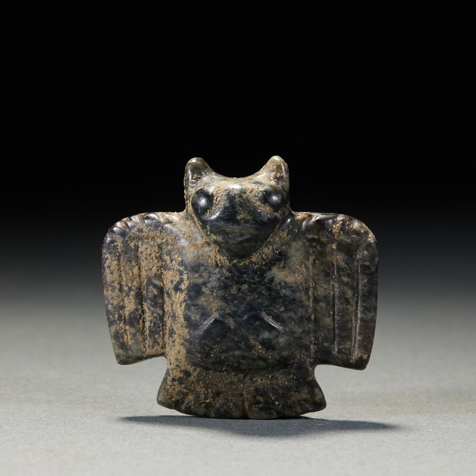 Jade Owl: A jade owl, plump, round staring eyes, wings folded. Warm calcified jade ?? an archaic owl symbolising warding off evil and guarding the home. H 4.4 cm, L 4.5 cm, W 1.5 cm, 32 g.