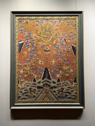 Mid-Qing Couched-Gold Robe-Panel Dragon: Mid-Qing couched-gold embroidery of dragons on a robe panel, the dragons coiled in gold thread, brilliant, intricate in craft ?? a Qing court or noble robe panel. L 111 cm, W 83 cm.
