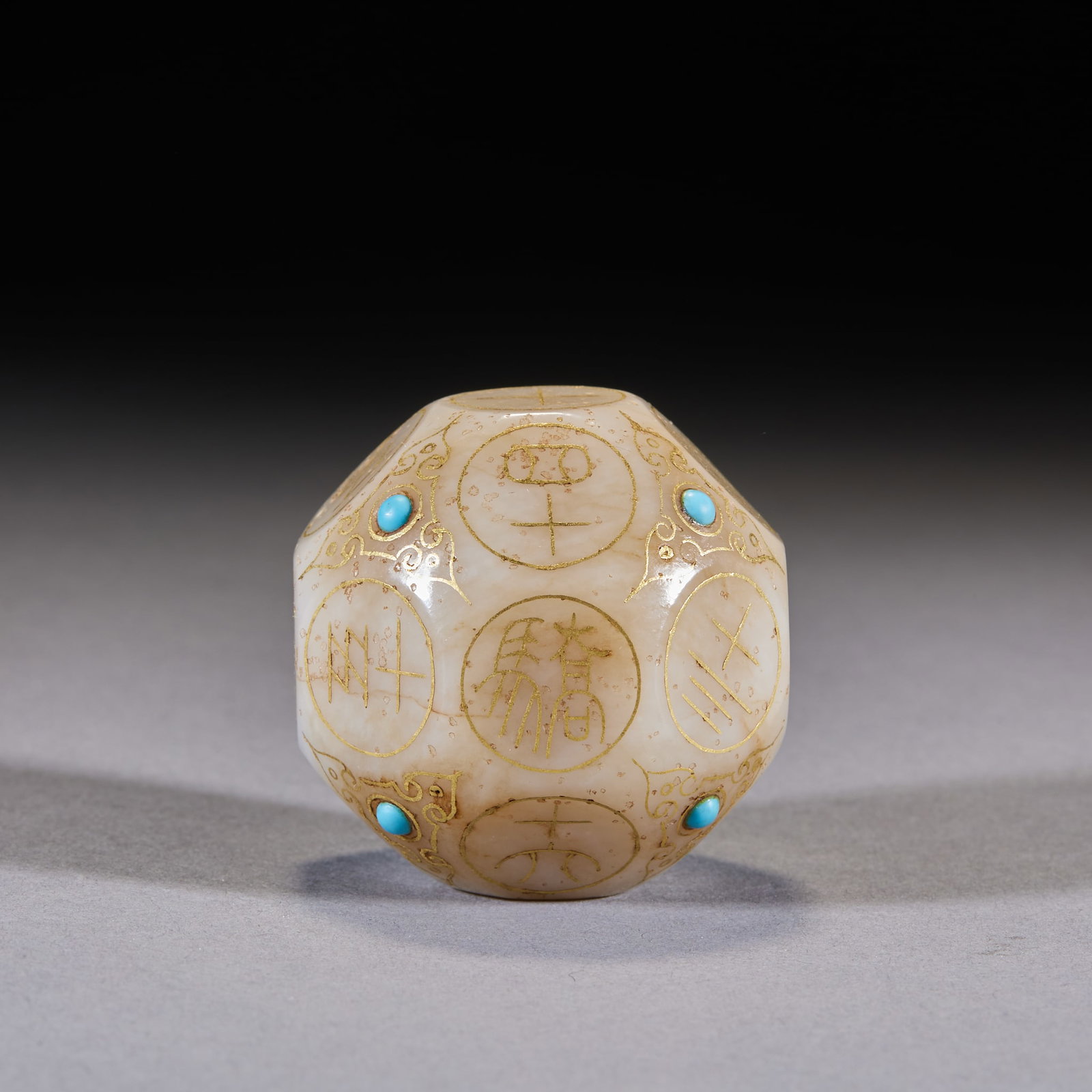 Han-Dynasty Jade Gold-Inlaid Gem-Inset Multi-Faced Die: A Han-dynasty jade multi-faced die, gold-inlaid and gem-inset on the faces. Warm jade and fine craft ?? a Han noble's gaming implement, extremely precious. L 5 cm, W 5 cm.