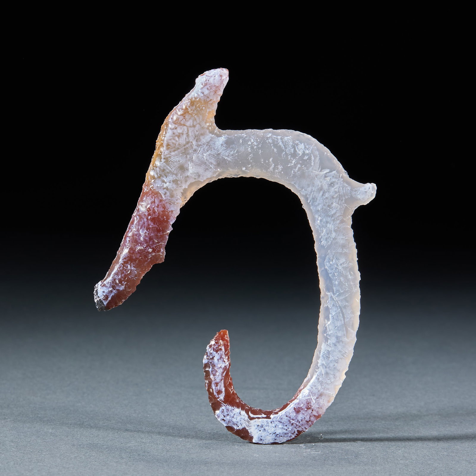 Agate C-Shaped Dragon: An agate C-shaped dragon, body curled into a C, head raised and tail curled, archaic. The agate is warm ?? an agate imitation of the Hongshan jade-dragon style. L 10 cm, W 7.5 cm, 20 g.