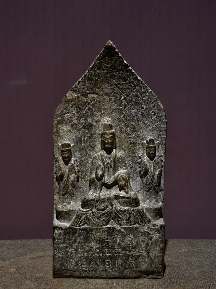 Grey-Stone Buddha with Backrest: A grey-stone seated Buddha with a backrest, in lotus position, solemn face. Grey stone, archaic carving ?? a Buddhist image. H 36 cm, L 18 cm, W 8 cm.