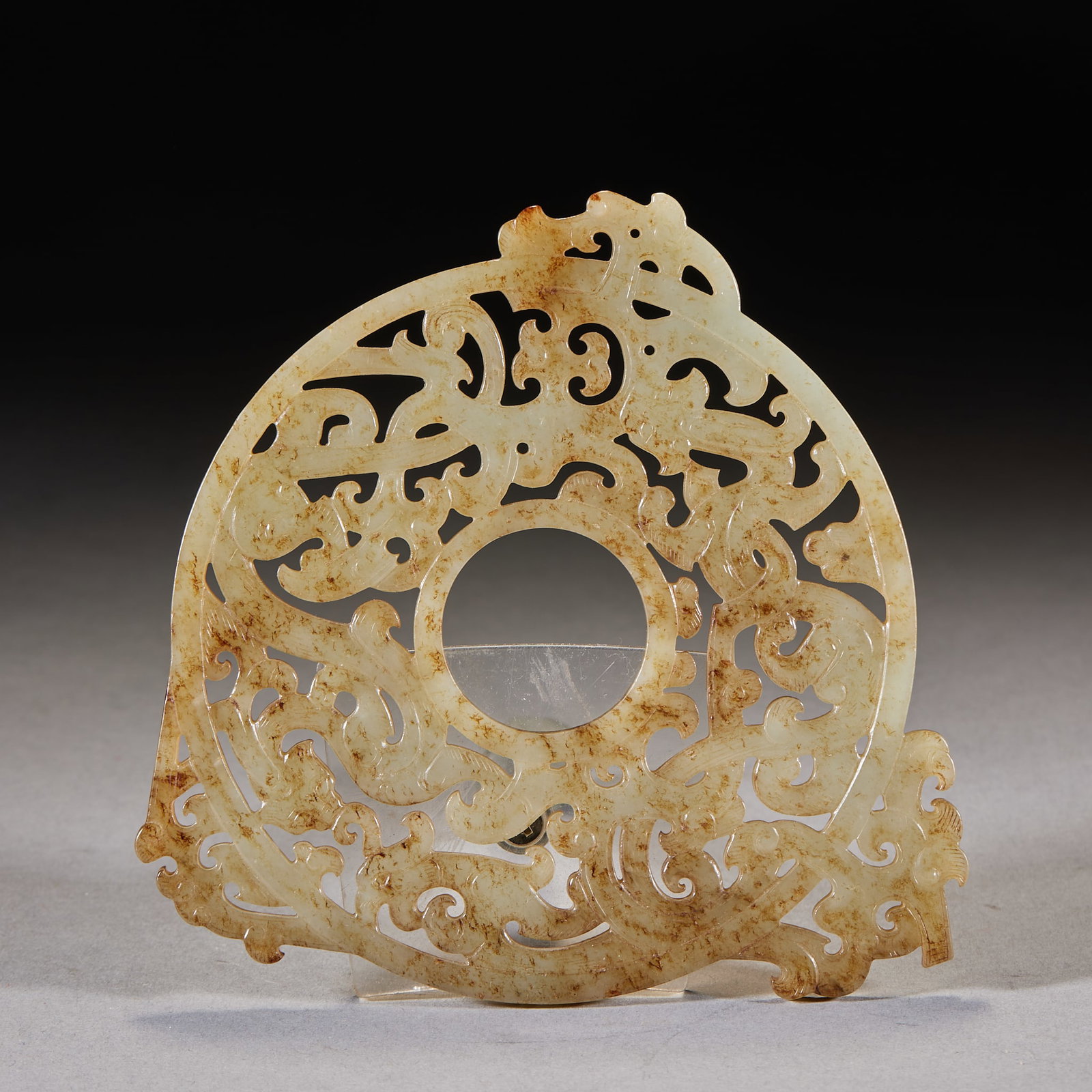 Han-Dynasty Openwork Dragon-Phoenix Outshaped Bi: A Han jade bi, round, with dragon-phoenix pierced in openwork outside the disc as outshaping. Warm calcified jade with exquisite openwork ?? a fine Han jade bi. Diameter 13 cm.