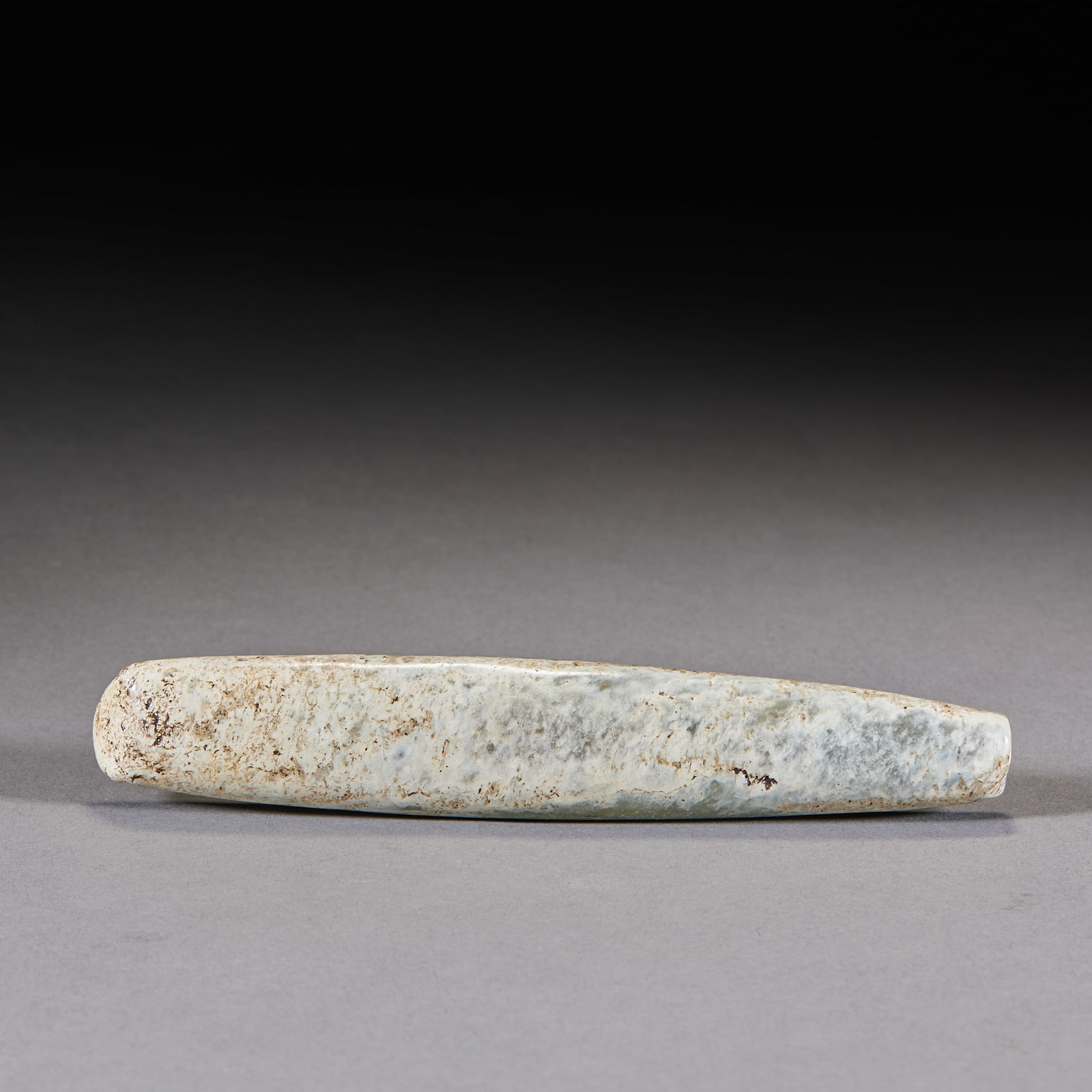 Hongshan Jade Object: A Hongshan jade object, warm and calcified, archaic and simple, a pendant or ritual piece. A Hongshan-culture jade of prehistoric cultural value. H 14.7 cm, L 2.5 cm, W 1.4 cm, 107 g.