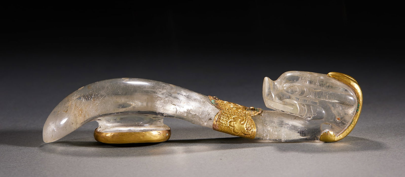Crystal Belt Hook: A crystal belt hook, in an arc form with the hook head curling back. Clear crystal, finely polished ?? an ancient dress implement. T 3 cm, L 15 cm, W 3.3 cm, 183 g.